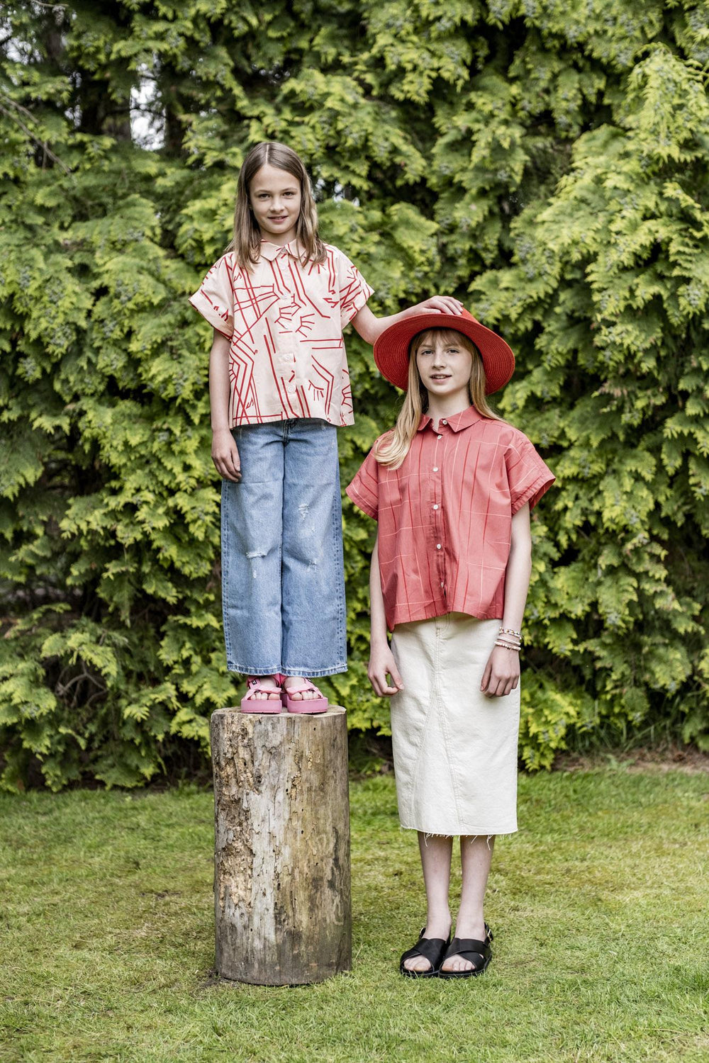 Children wearing the Children's Kira Blouse sewing pattern from Fibre Mood on The Fold Line. A blouse pattern made in poplin, chambray, lyocell, double gauze, organza, seersucker, and linen fabric, featuring an oversized silhouette, button front closure,
