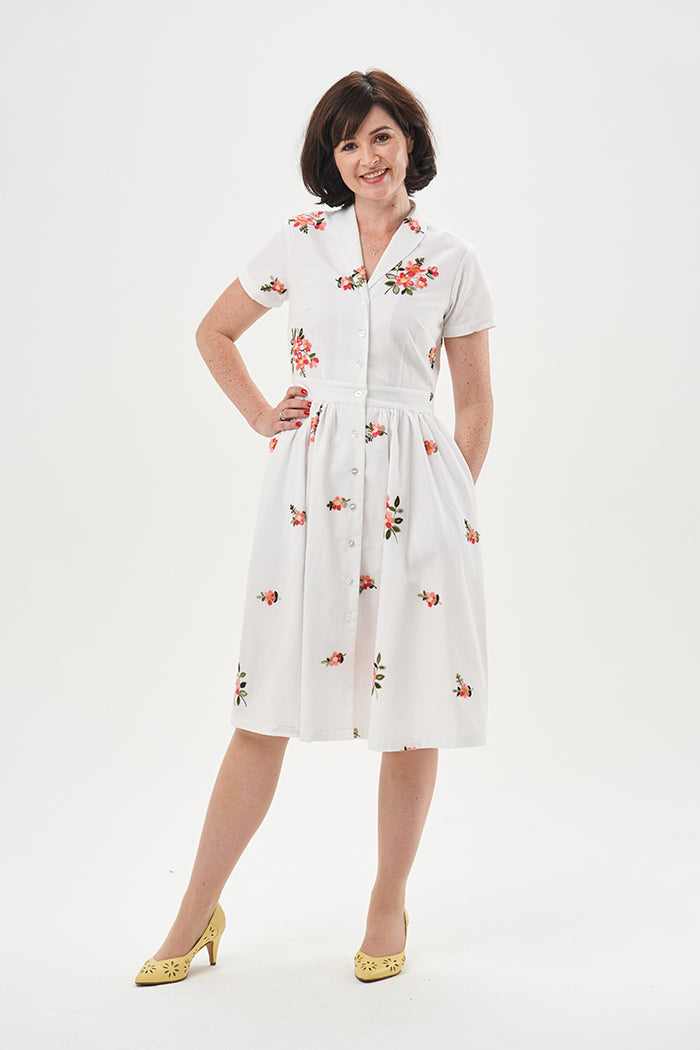 Woman wearing the Kitty Dress sewing pattern from Sew Over It on The Fold Line. A dress pattern made in rayon, viscose, crepe, cotton, cotton lawn, linen, or seersucker fabric, featuring a vintage-inspired silhouette, button front, shawl collar, bust dart