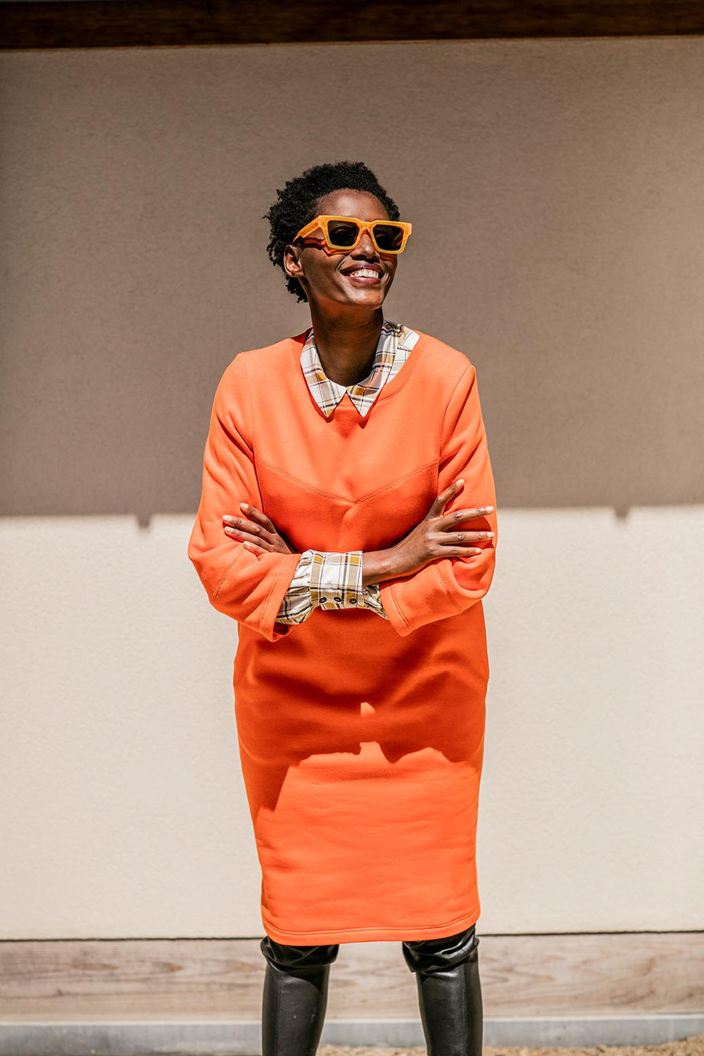 Woman wearing the Lexi Dress sewing pattern from Fibre Mood on The Fold Line. A dress pattern made in French terry fabrics, featuring side seam pockets, slight cocoon shape, round neck, ¾ length puff sleeves and knee length hem.