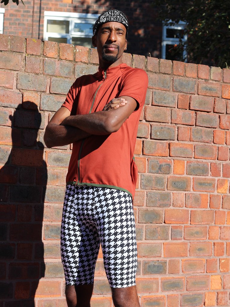 Man wearing the Men's Lightspeed Leggings sewing pattern from Fehr Trade on The Fold Line. A leggings pattern made in lycra fabric, featuring a roomy front pouch, rear panel with zippered pocket, elasticated waistband, and above knee length.