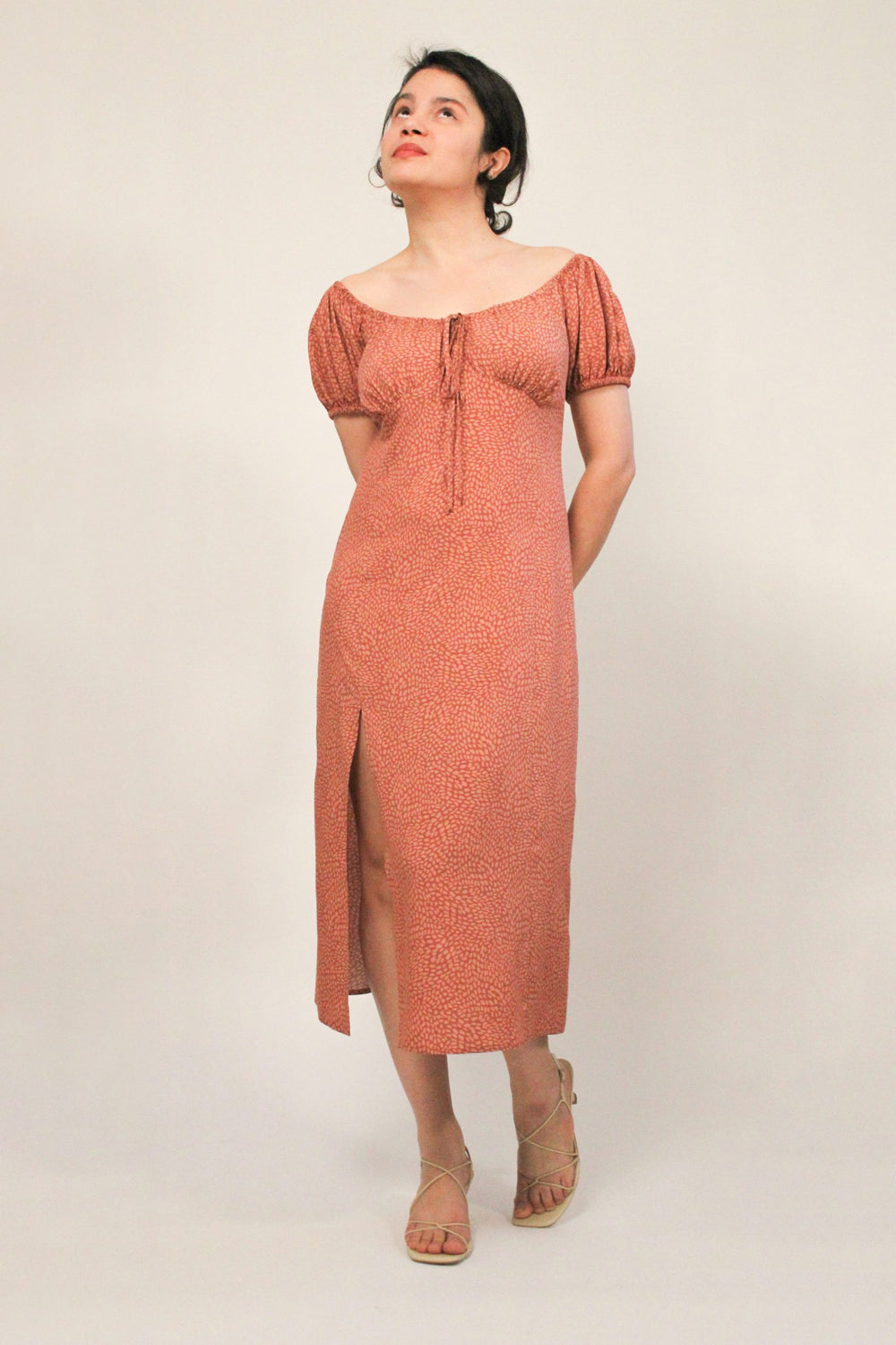 Woman wearing the Linda Dress sewing pattern from Bella Loves Patterns on The Fold Line. A dress pattern made in tencel, silk, viscose, rayon challis, linen viscose blends or tencel blends fabrics, featuring a column style, fitted at the waistline, puffy