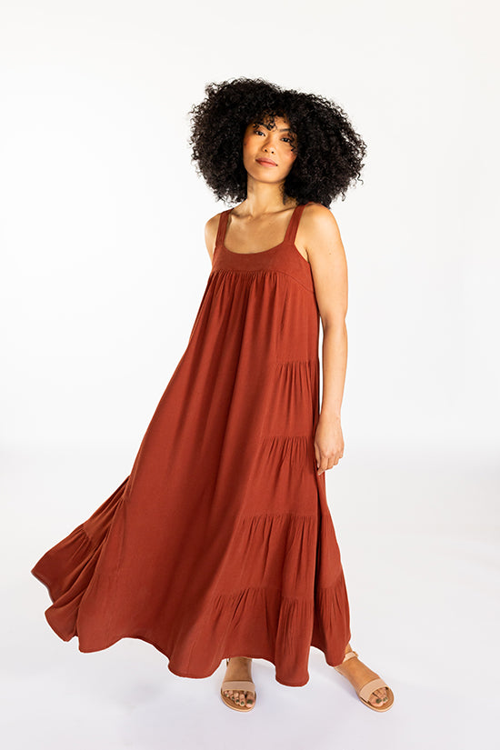 Woman wearing the Marcel Dress sewing pattern from Chalk and Notch on The Fold Line. A sleeveless, midi dress pattern made in rayon challis, rayon crepe, rayon voile, cotton lawn, cotton voile, cotton shirting or linen fabrics, featuring a fitted high bus