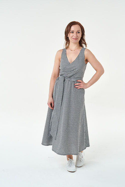 Woman wearing the Martha Dress sewing pattern from Sew Over It on The Fold Line. A dress pattern made in cotton, poplin, sateen, viscose linen blends, viscose twill, seersuckers, chambray, crepes or brocade fabrics, featuring bust darts, wrap over bodice