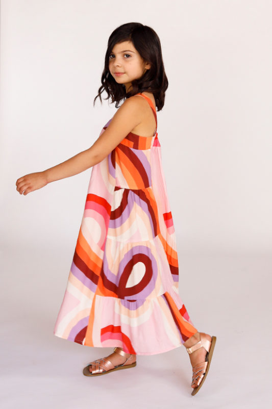 Child wearing the Baby/Child Mini Marcel Dress sewing pattern by Chalk and Notch. A slip on dress pattern made in light to medium weight woven fabrics with a nice drape, featuring a loose fit through the waist and hips and fitted through the chest, narrow