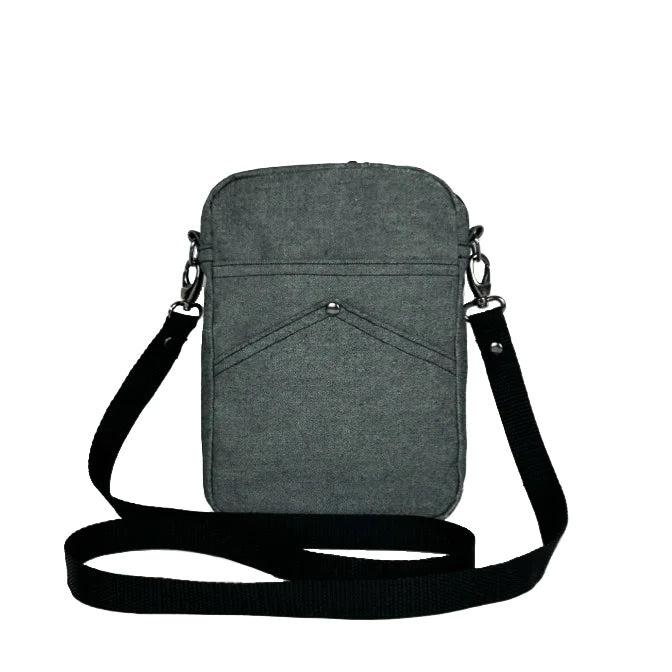 Image showing the Minnie Bag sewing pattern from Dhurata Davies Patterns on The Fold Line. A crossbody bag pattern made in medium weight woven fabrics, featuring a rectangular silhouette, two front pockets, inner pocket, removable strap, zip closure, and