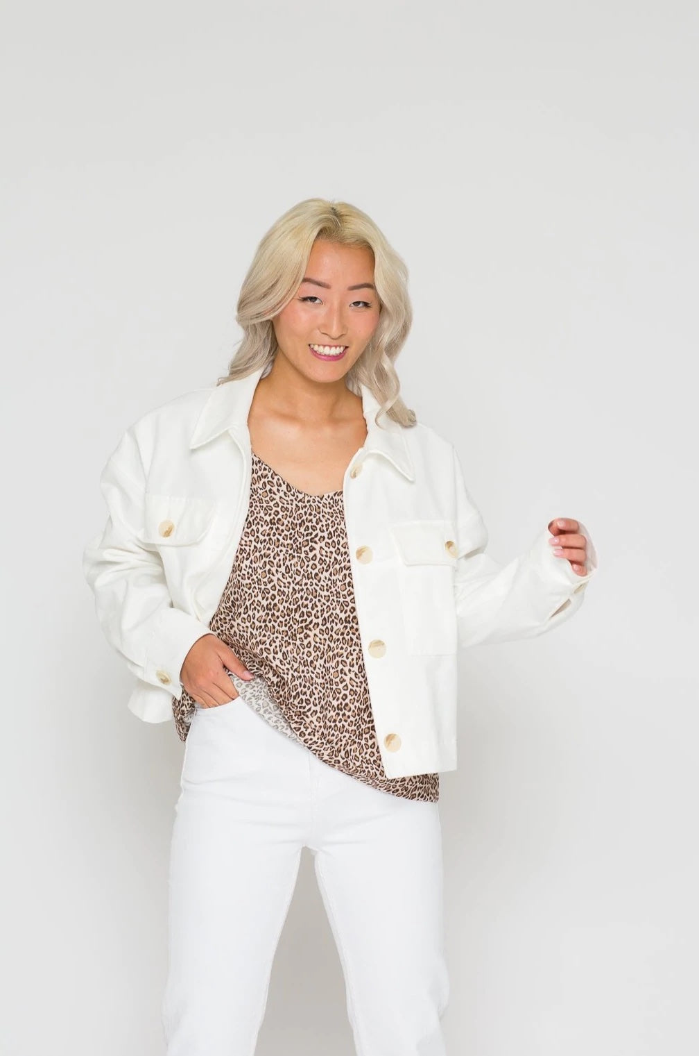Woman wearing the Noomi Denim Jacket sewing pattern from Bara Studio on The Fold Line. A jacket pattern made in denim fabrics, featuring dropped shoulders, back yoke with tab, chest patch pockets with button flaps, boxy cut, front button closure and full