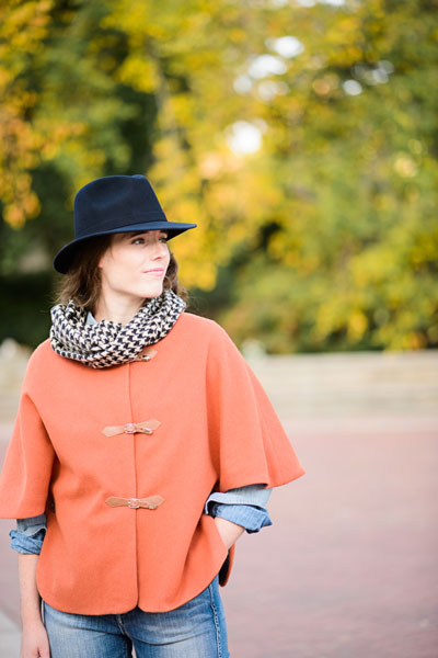 Woman wearing the Woodland Stroll Cape sewing pattern from Liesl + Co on The Fold Line. A cape pattern made in wool coating, wool melton, velveteen (cotton velvet), moleskin, or corduroy fabrics, featuring a full lining, round neck, elbow length sleeves,
