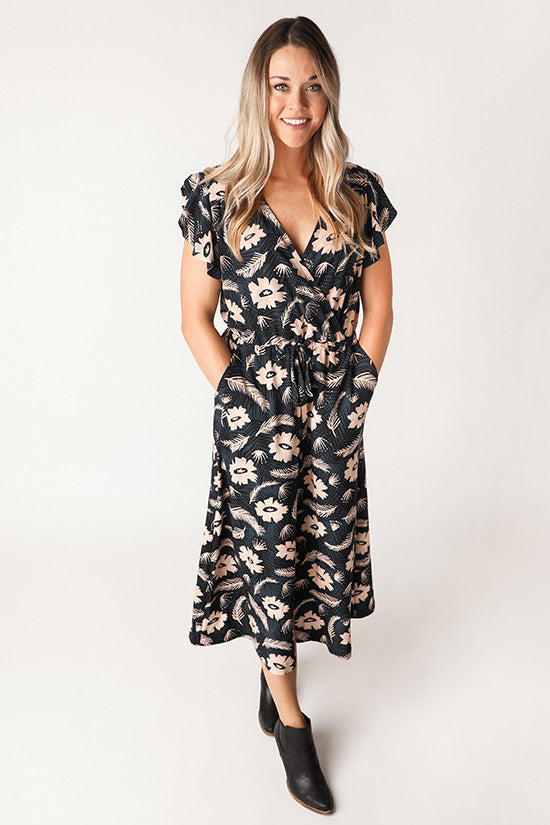 Woman wearing the Orchid Midi Dress sewing pattern from Chalk and Notch on The Fold Line. A wrap dress pattern made in rayon challis, rayon crepe, rayon voile, cotton lawn, cotton voile, linen or double gauze fabrics, featuring ruffle sleeves, an elastic