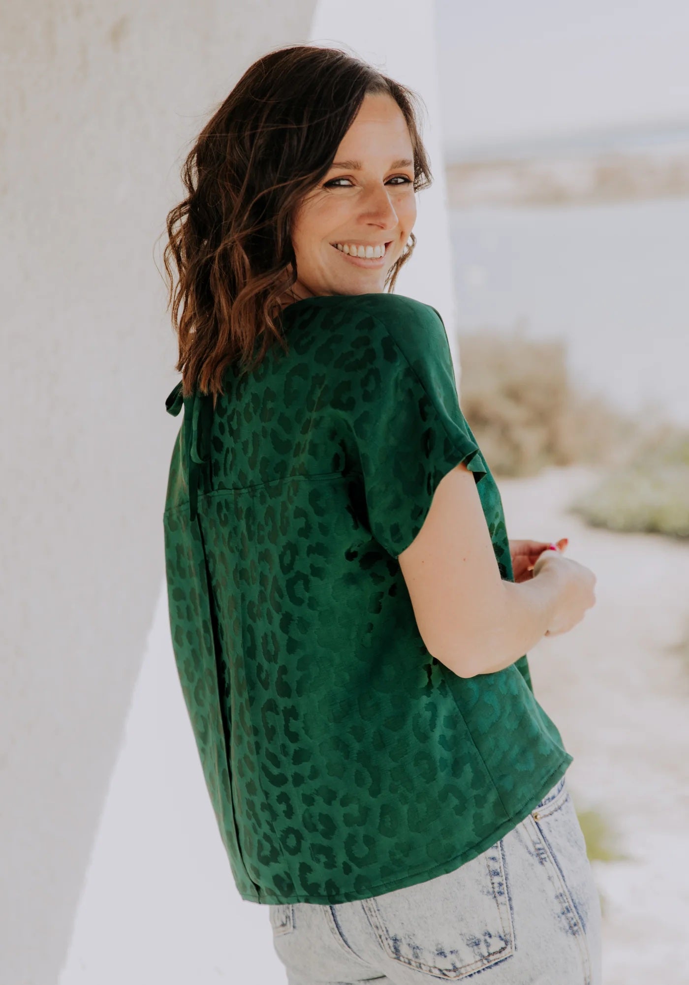 Woman wearing the Palma Top sewing pattern from Maison Fauve on The Fold Line. A blouse pattern made in viscose crepe or twill, silk, cotton poplin, embroidered voile, linen/viscose, or cotton satin fabric, featuring an oversized cut, scoop neckline, and