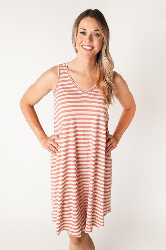 Woman wearing the Pony Tank Dress sewing pattern by Chalk and Notch. A swing shaped, sleeveless, knit dress pattern made in light weight to medium weight 75% – 100% stretch knit fabrics, featuring a curved hem and V-neck.