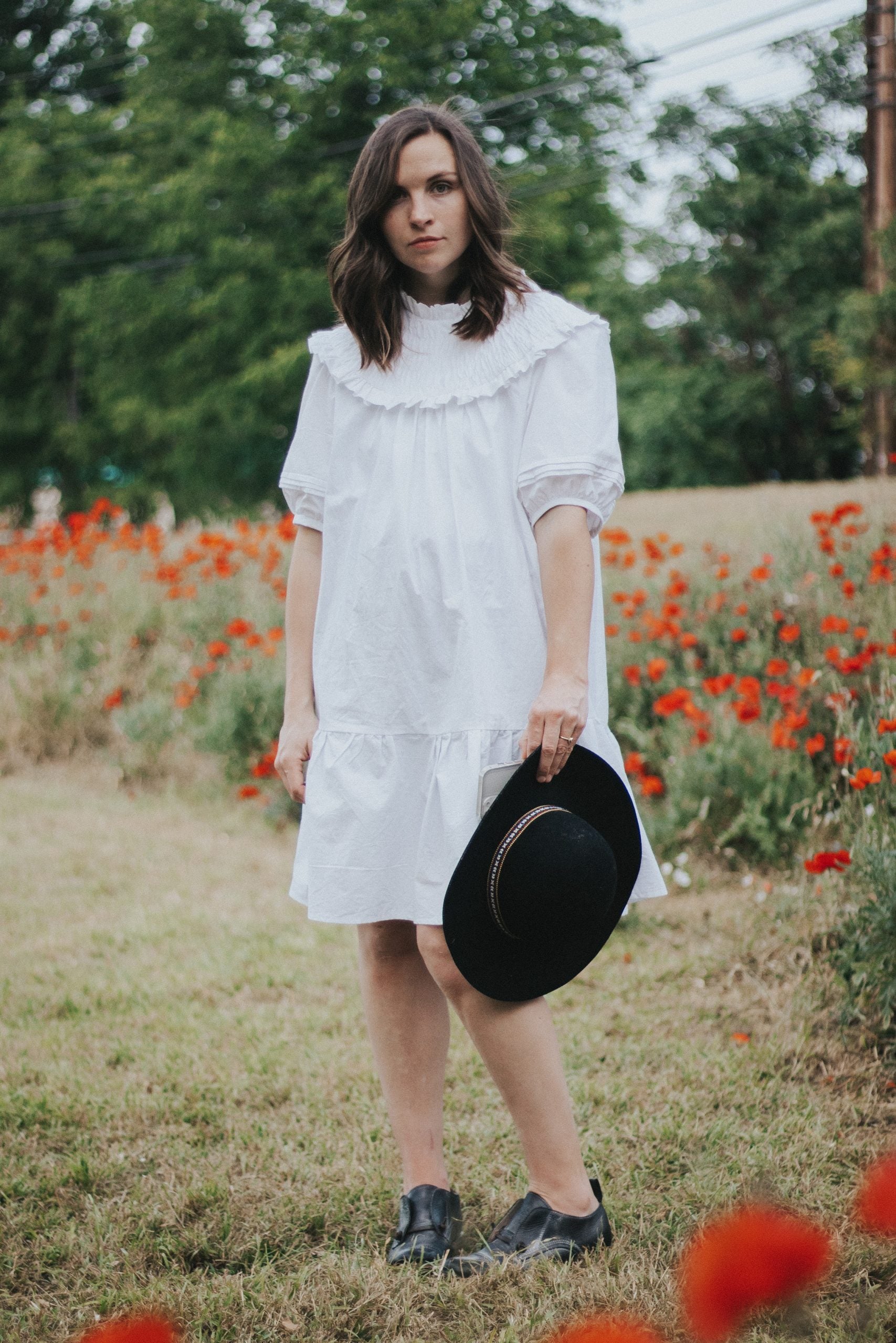 Woman wearing the Raida Dress sewing pattern from Madswick on The Fold Line. A dress pattern made in linen, cottons, lyocell, shirting, viscose crepe, or viscose-linen-noil fabrics, featuring a circular ruffled yoke, billowy bodice, elbow length gathered