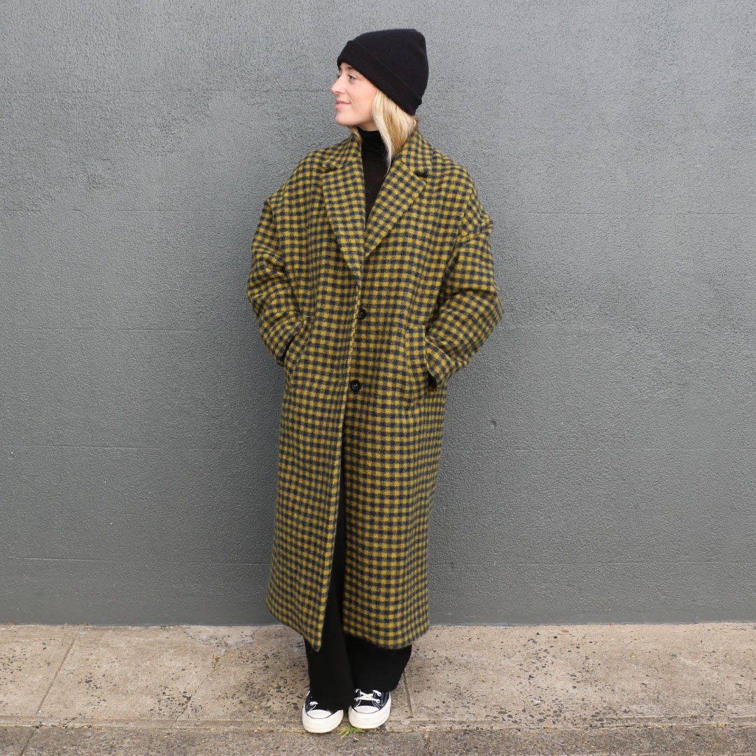 Woman wearing the Richmond Coat sewing pattern from Tessuti on The Fold Line. A coat pattern made in wool coating, wool blend coating, double wool crepe or wool boucle fabric, featuring single breasted, full length, oversized, drop shoulders, tapered slee
