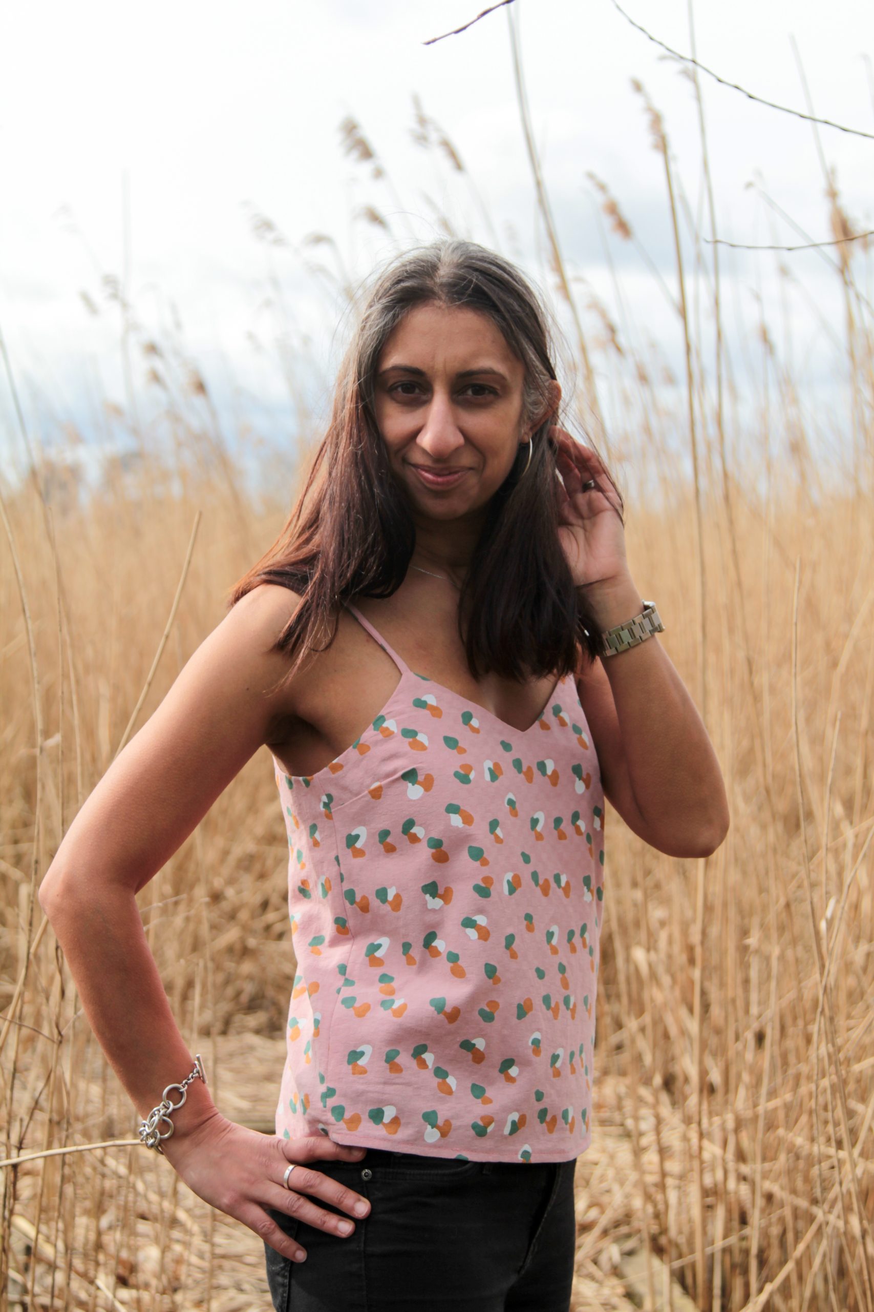 Woman wearing the Riviera Cami sewing pattern by Make With Mandi. A camisole pattern made in chiffon, cotton poplin, viscose, rayon or linen fabrics, featuring bust darts, bias cut spaghetti straps and a V-neck.