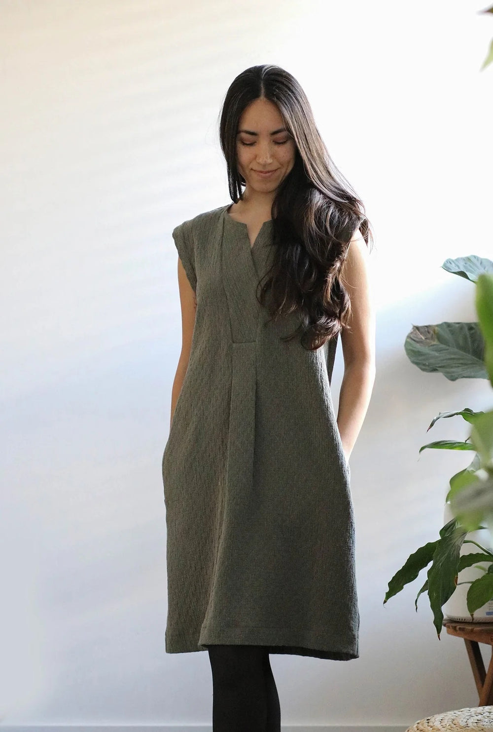 Woman wearing the Sawtell Dress sewing pattern from In the Folds on The Fold Line. A dress pattern made in linen, linen blends, cotton and lightweight denim fabrics, featuring a knee length, inset placket with pleats, bust darts, back yoke, back box pleat