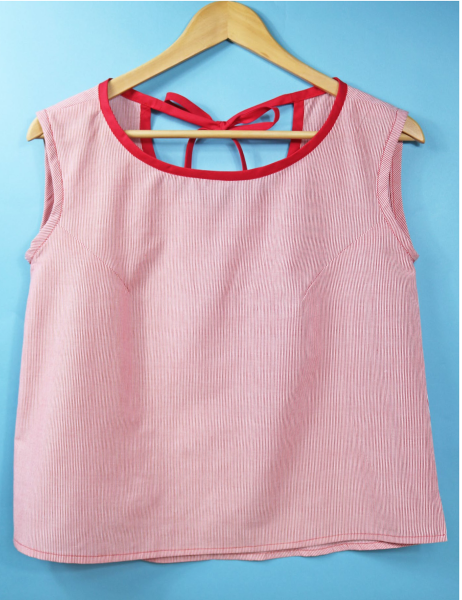 Image showing the Hello Sailor Top sewing pattern by The Fold Line. A camisole top pattern made in light weight cotton, cotton lawn, shirting or rayon fabrics, featuring armhole darts and fitted around the bust, back bias ribbon tie, and side seam slits.