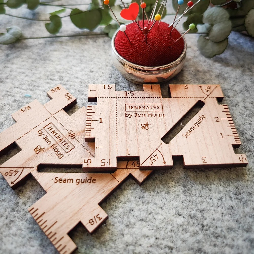 Photo of the Seam Guide from Jenerates on The Fold Line. A cherry wood seam guide, in centimetres or inches, useful for checking your seams and hems, with a cut out to mark a 45° angle for mitred corners.