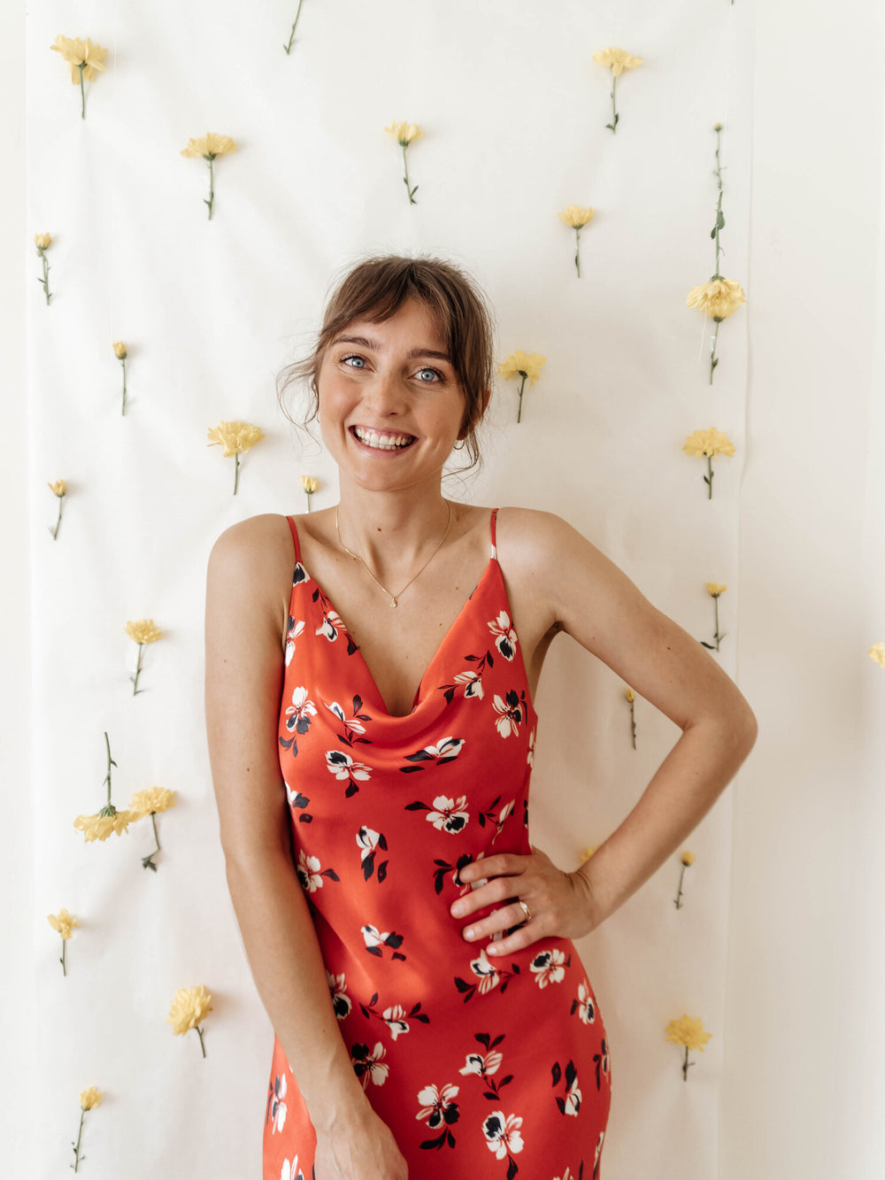 Woman wearing the Sicily Slip Dress sewing pattern from Sewing Patterns by Masin on The Fold Line. A sleeveless, slip dress pattern made in satins, lightweight crepes, rayon/viscose, chiffon or charmeuse fabrics, featuring a bias cut, narrow shoulder stra
