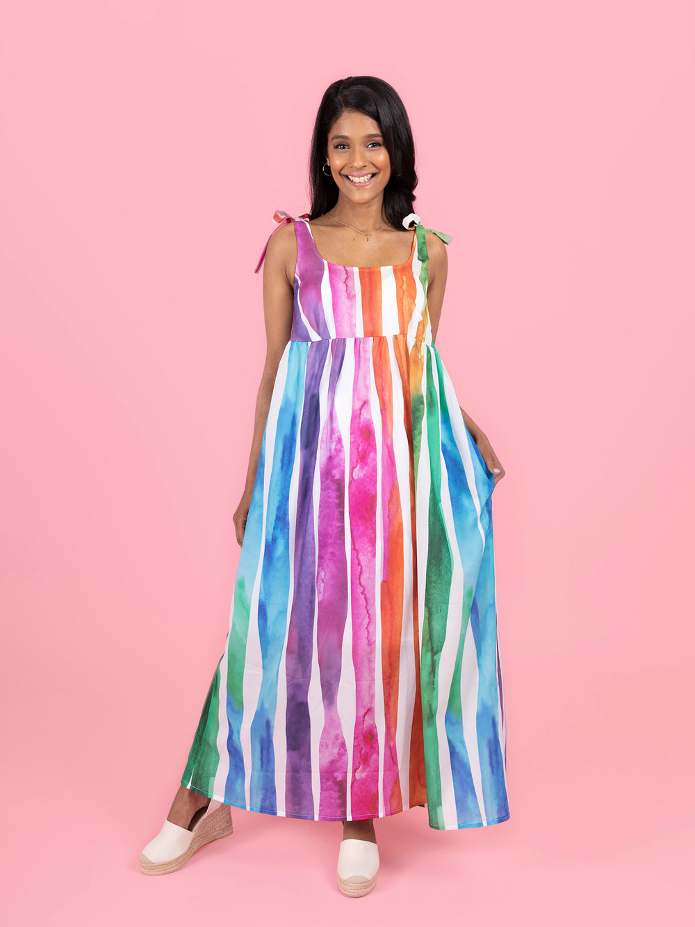 Woman wearing the Skye Sundress sewing pattern from Tilly and the Buttons on The Fold Line. A sun dress pattern made in cotton lawn, poplin, seersucker, linens, double gauze, viscose (rayon), silk or poly crepe de chine fabrics, featuring a relaxed fit, e