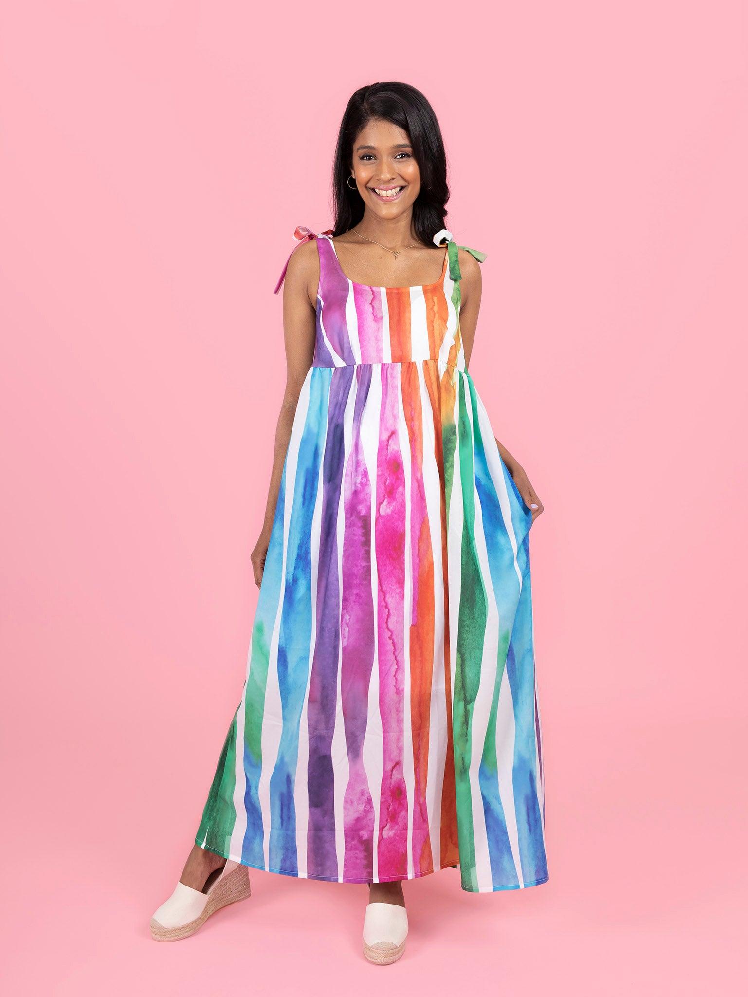 Woman wearing the Skye Sundress sewing pattern from Tilly and the Buttons on The Fold Line. A sun dress pattern made in cotton lawn, poplin, seersucker, linens, double gauze, viscose (rayon), silk or poly crepe de chine fabrics, featuring a relaxed fit, e