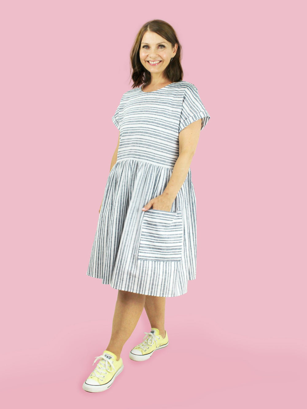 Woman wearing the Stevie Tunic sewing pattern from Tilly and the Buttons on The Fold Line. A dress pattern made in linen, double gauze, chambray, cotton lawn or viscose fabrics, featuring add-ons such as three-quarter length sleeves, gathered skirt and ex