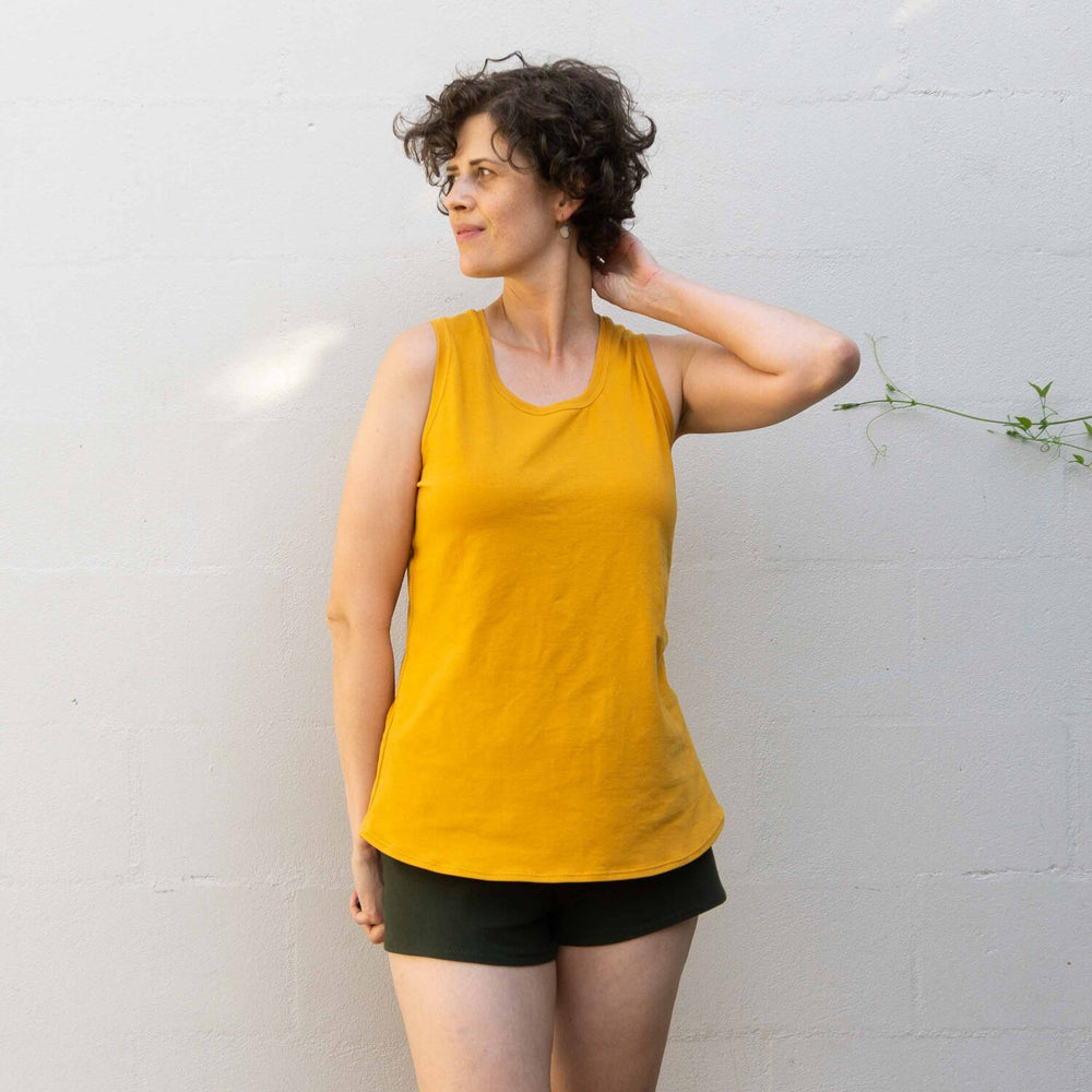 Women wearing the Summer Sweatsuit sewing pattern from Sew DIY on The Fold Line. A top and shorts pattern made in light to medium weight knit fabrics, featuring a racerback tank with full back coverage, curved hem and scoop neck. The shorts are mid-rise,