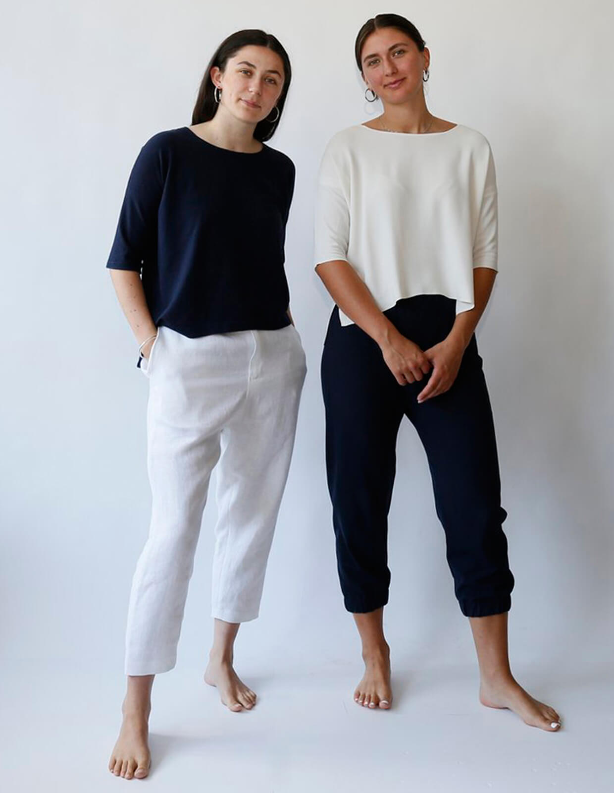 Women wearing the Lounge Pant sewing pattern from The Maker's Atelier on The Fold Line. A trouser pattern made in cotton drill, linen, denim and other mid-weight woven fabrics, featuring a looser fit, lower crotch, cropped length, back patch pockets, fly