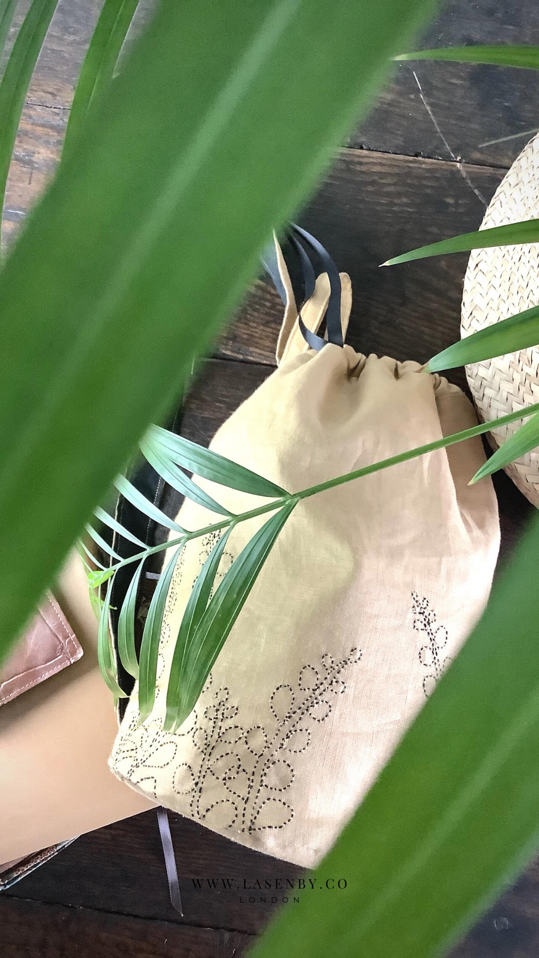 Photo showing the Fern Crossbody Duffle Bag sewing pattern from Lasenby on The Fold Line. A duffle bag pattern made in canvas, linen, quilting cotton, twill, duck, denim, fine tweed, and Tana lawn fabrics, featuring a sashiko embroidery design, back strap