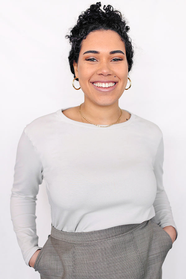 Woman wearing the Basic Long Sleeve Top sewing pattern from JULIANA MARTEJEVS on The Fold Line. A tee pattern made in jersey fabric, featuring a fitted silhouette, round neck, and long sleeves.