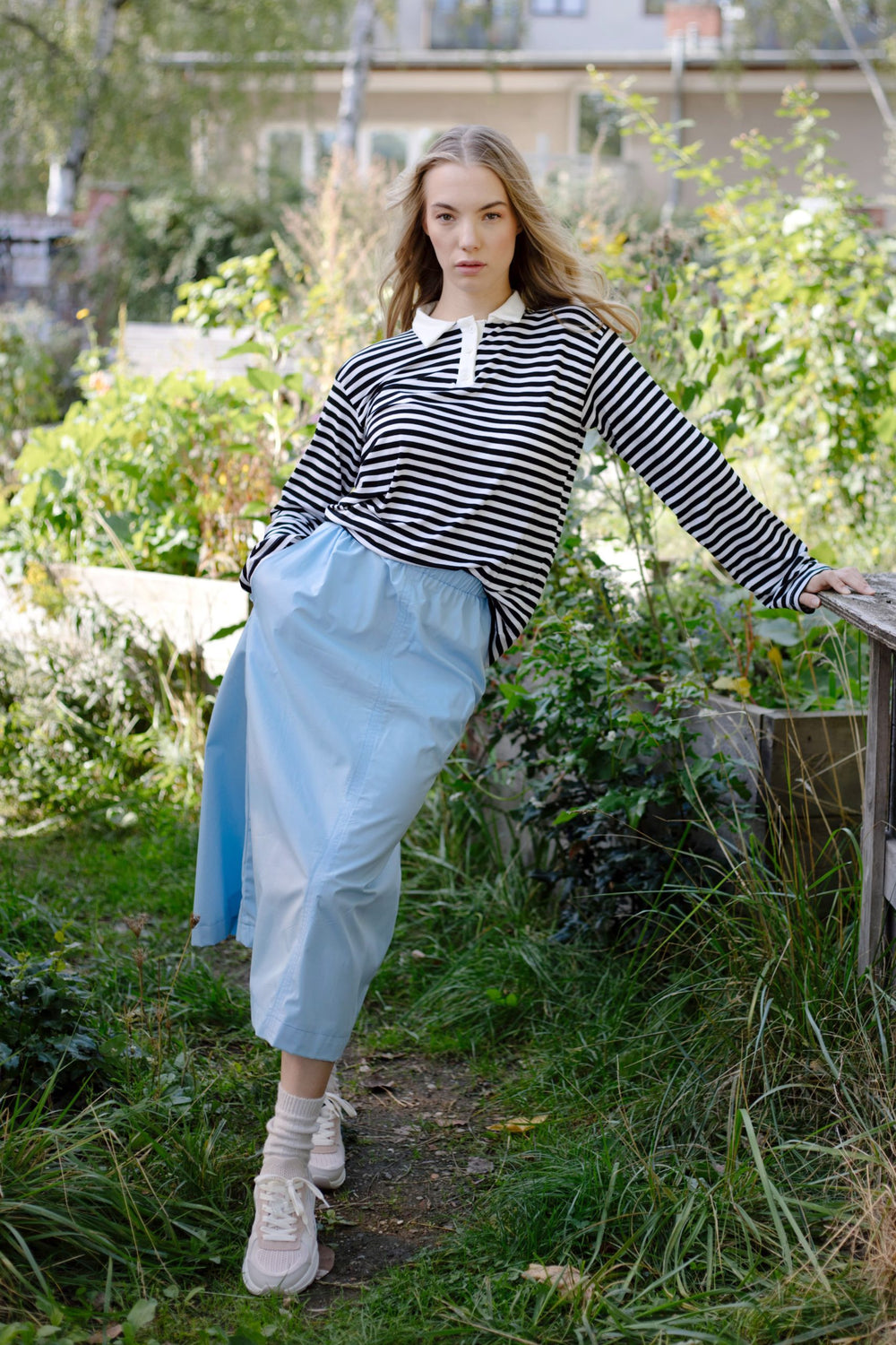 Woman wearing the Holly Skirt sewing pattern from JULIANA MARTEJEVS on The Fold Line. A skirt pattern made in cotton poplin fabrics, featuring a midi length, elastic waistband, in-seam pockets and relaxed fit.