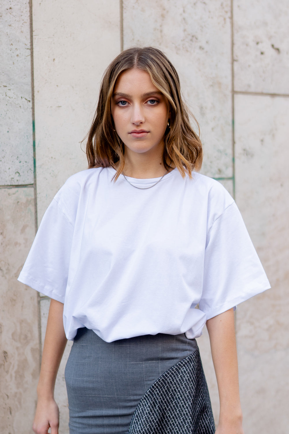 Woman wearing the Oversized T-shirt sewing pattern from JULIANA MARTEJEVS on The Fold Line. A T-shirt pattern made in cotton jersey fabrics, featuring a relaxed fit, round neck and elbow length sleeves.