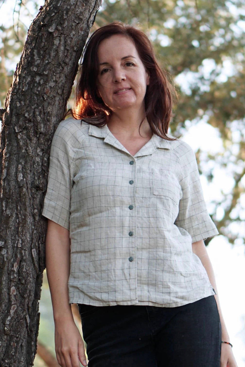 Woman wearing Tropicana Shirt sewing pattern from Wardrobe by Me on The Fold Line. A shirt pattern made in cotton, linen or silk fabrics, featuring raglan sleeves, slit cuffs, elbow length sleeves, chest pocket, relaxed fit, collar and front button closur