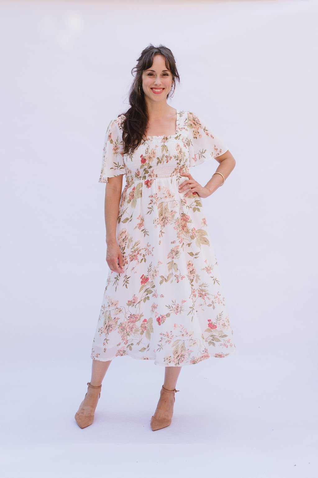 Woman wearing the Sofia Dress sewing pattern from Victory Patterns on The Fold Line. A dress pattern made in cotton, gingham, broadcloth, rayon, linen, single gauze, or crepe fabrics, featuring an elasticated waist length shirred bodice, square neckline,