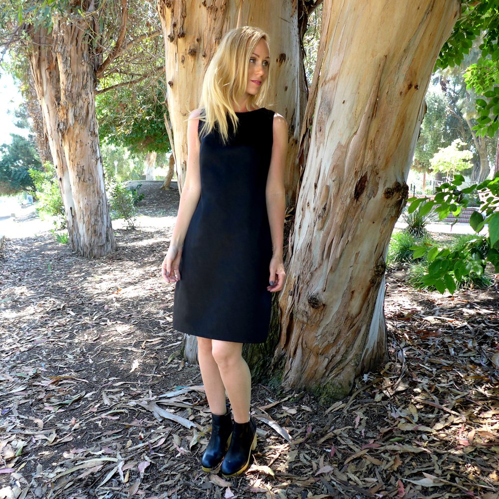 Woman wearing the Varda Dress sewing pattern from Christine Haynes on The Fold Line. A dress pattern made in linen, lawn, shirting, and chambray fabrics, featuring a semi fitted silhouette, bust darts, centre back invisible zip closure, back darts, short