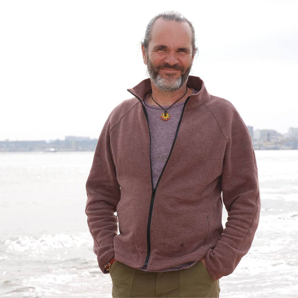 Man wearing the Men's Fleece Jacket sewing pattern from Wardrobe by Me on The Fold Line. A fleece jacket pattern made in fleece, French terry or sweatshirt fabrics, featuring a slim-fit, contoured body and sleeve seams, front zip pockets, inner zip pocket