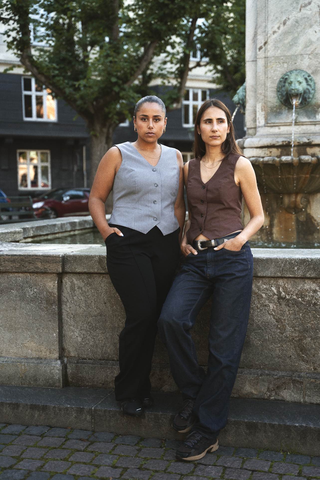 Women wearing the Waistcoat sewing pattern from Puff and Pencil on The Fold Line. A lined waistcoat pattern made in linen, cotton twill and wool suiting fabrics, featuring a fitted silhouette, adjustable back belt, princess seams, single faux welt pocket