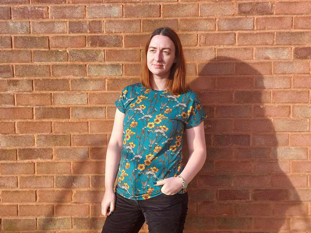 Woman wearing the Women’s Victory Dolman T-shirt sewing pattern from Waves & Wild on The Fold Line. A T-shirt pattern made in knit fabric such as cotton/lycra jersey, rayon/lycra jersey, or bamboo/lycra jersey, featuring a round neckline and short dolman