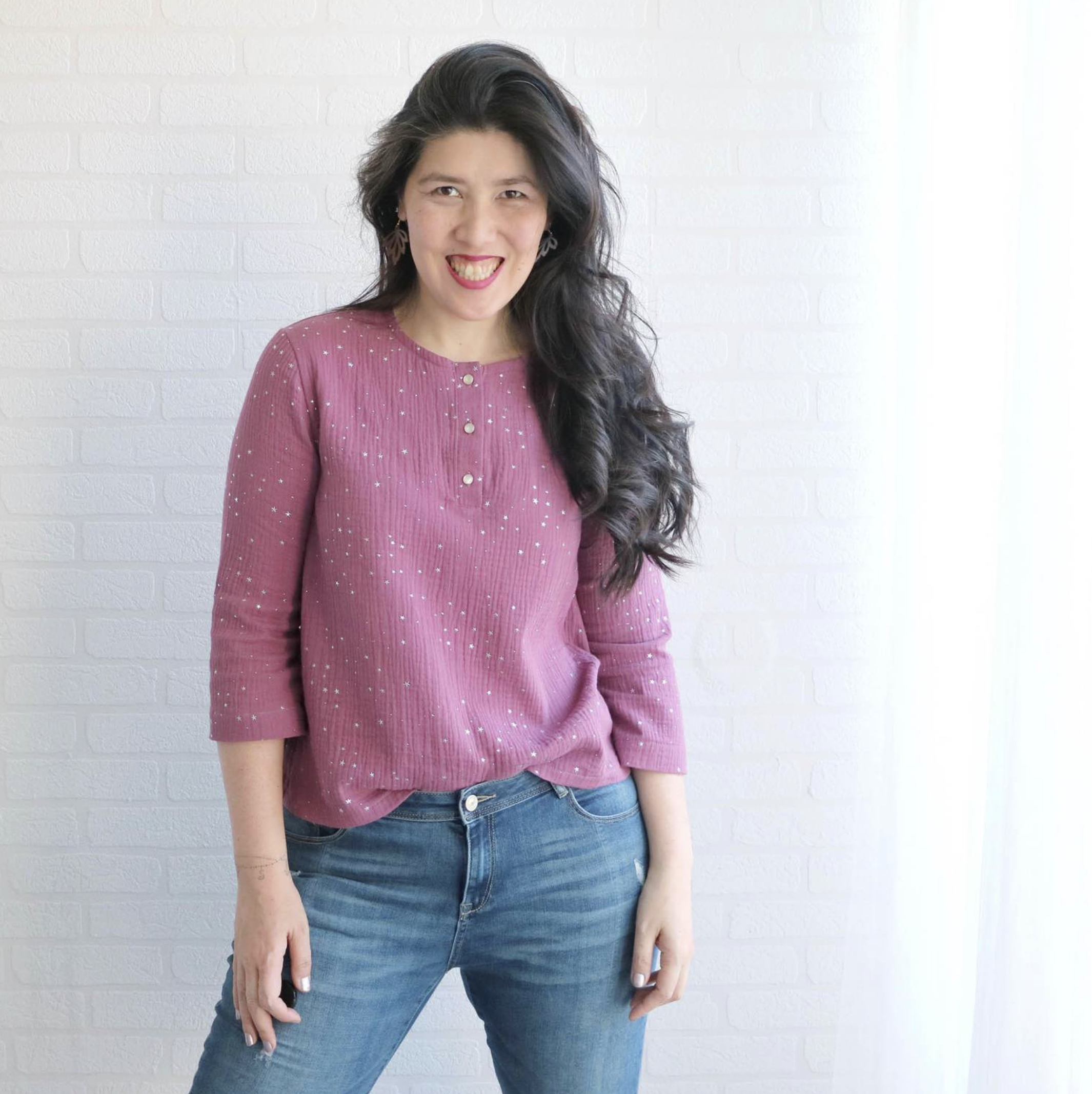 Woman wearing Whisper Blouse sewing pattern from Wardrobe by Me on The Fold Line. A top pattern made in double gauze fabrics, featuring a round neckline, front button placket, ¾ length sleeve and relaxed fit.