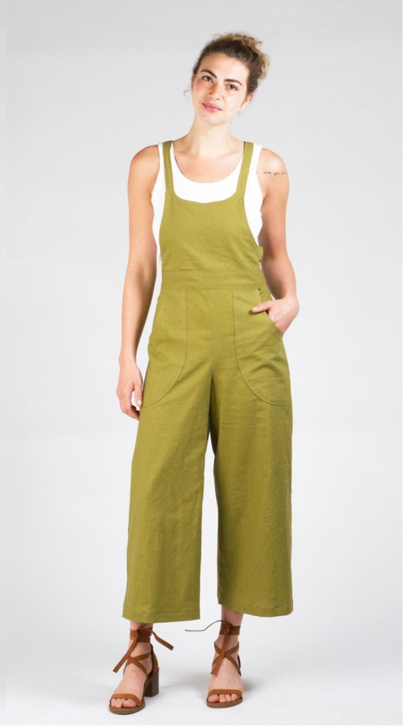 Woman wearing the Burnside Bibs sewing pattern from Sew House Seven on The Fold Line. A dungaree/overalls pattern made in Tencel, linen, gabardine, silk, denim or cotton twill fabrics, featuring narrow shoulder straps, front waistband, curved front patch