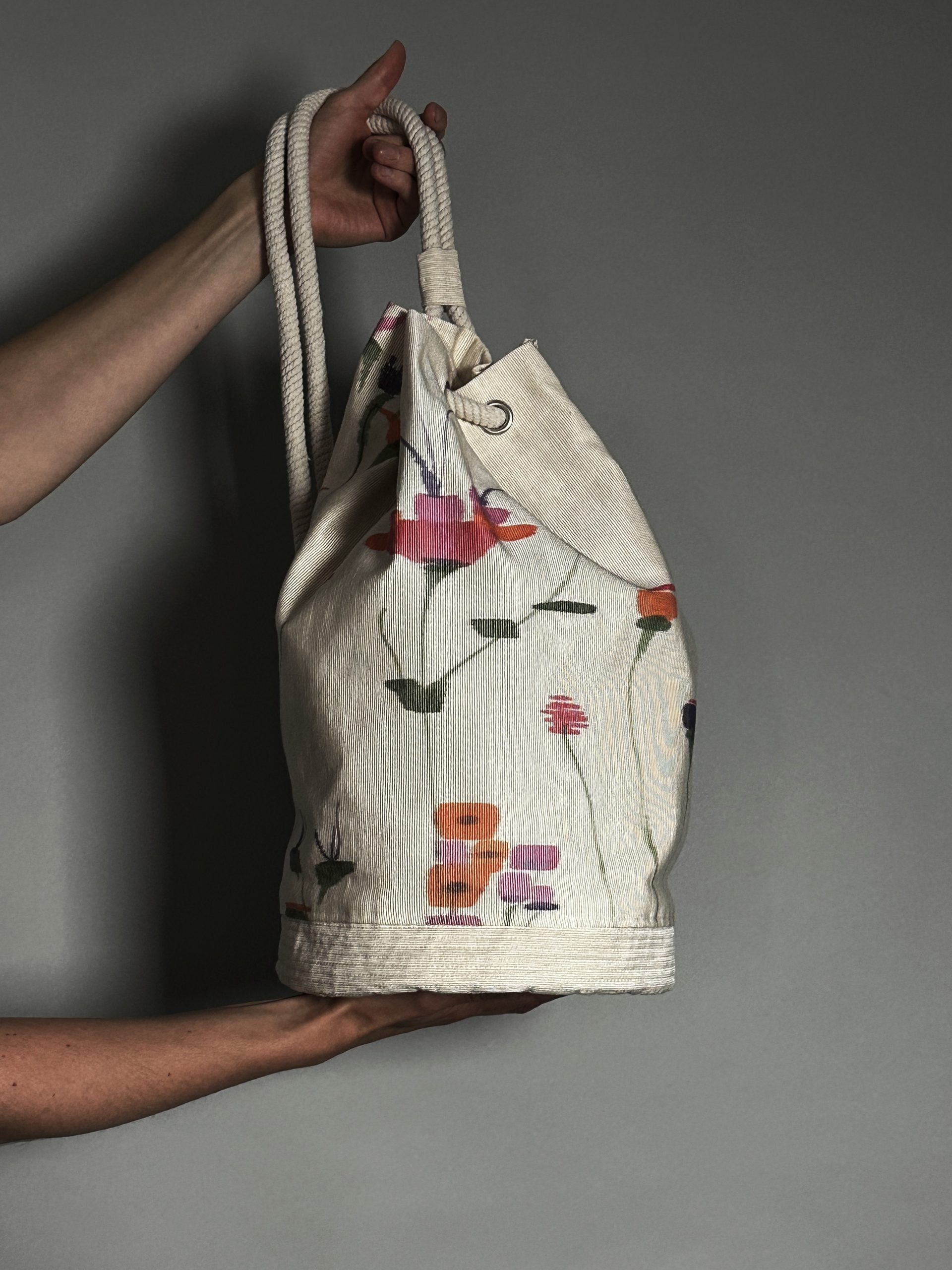 Photo showing the Hammershus Bag sewing pattern from How to Do Fashion on The Fold Line. A sailor’s ditty bag pattern made in cotton twill, denim or Panama fabrics, featuring a shoulder, crossbody or backpack multipurpose double drawstring handle and clos