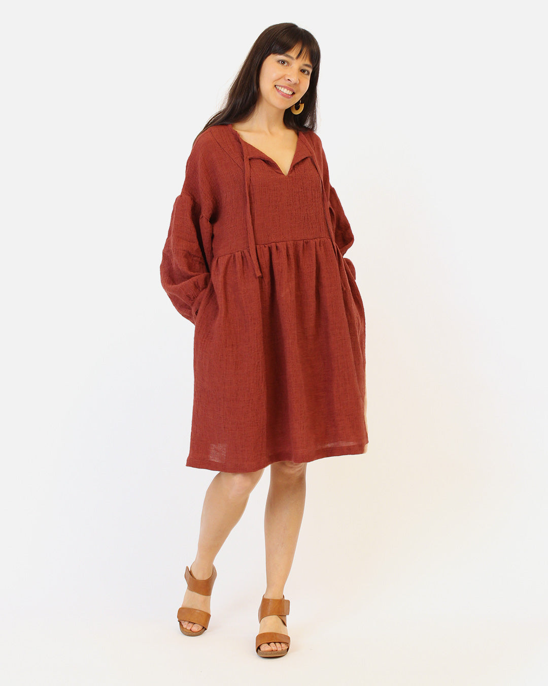 Woman wearing the March Dress sewing pattern by Helens Closet. A dress pattern made in light to medium weight woven fabrics with no stretch, featuring a relaxed fit, voluminous long sleeves, gathered skirt, and a neck tie that you can tie in the front or
