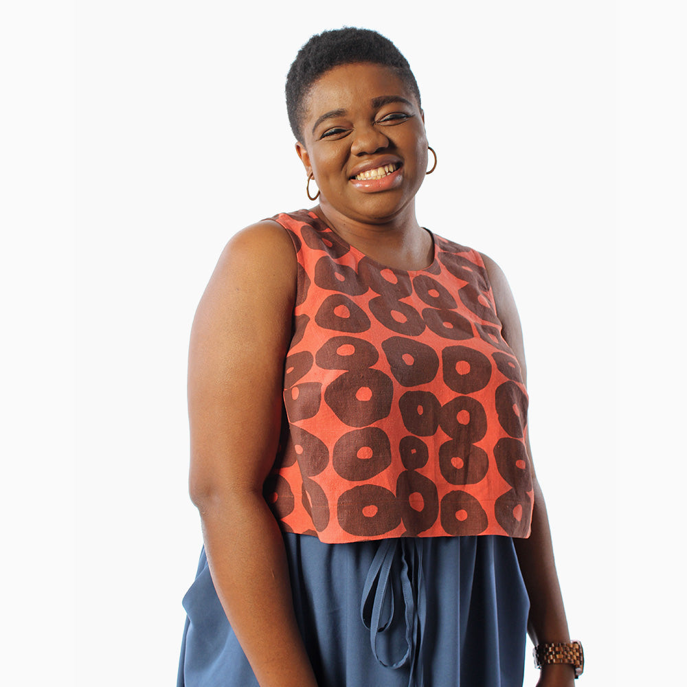 Woman wearing the Ashton Top sewing pattern from Helen's Closet on The Fold Line. A sleeveless top pattern made in medium weight cotton or linen fabrics, featuring bust darts, A-line shape and cropped length.