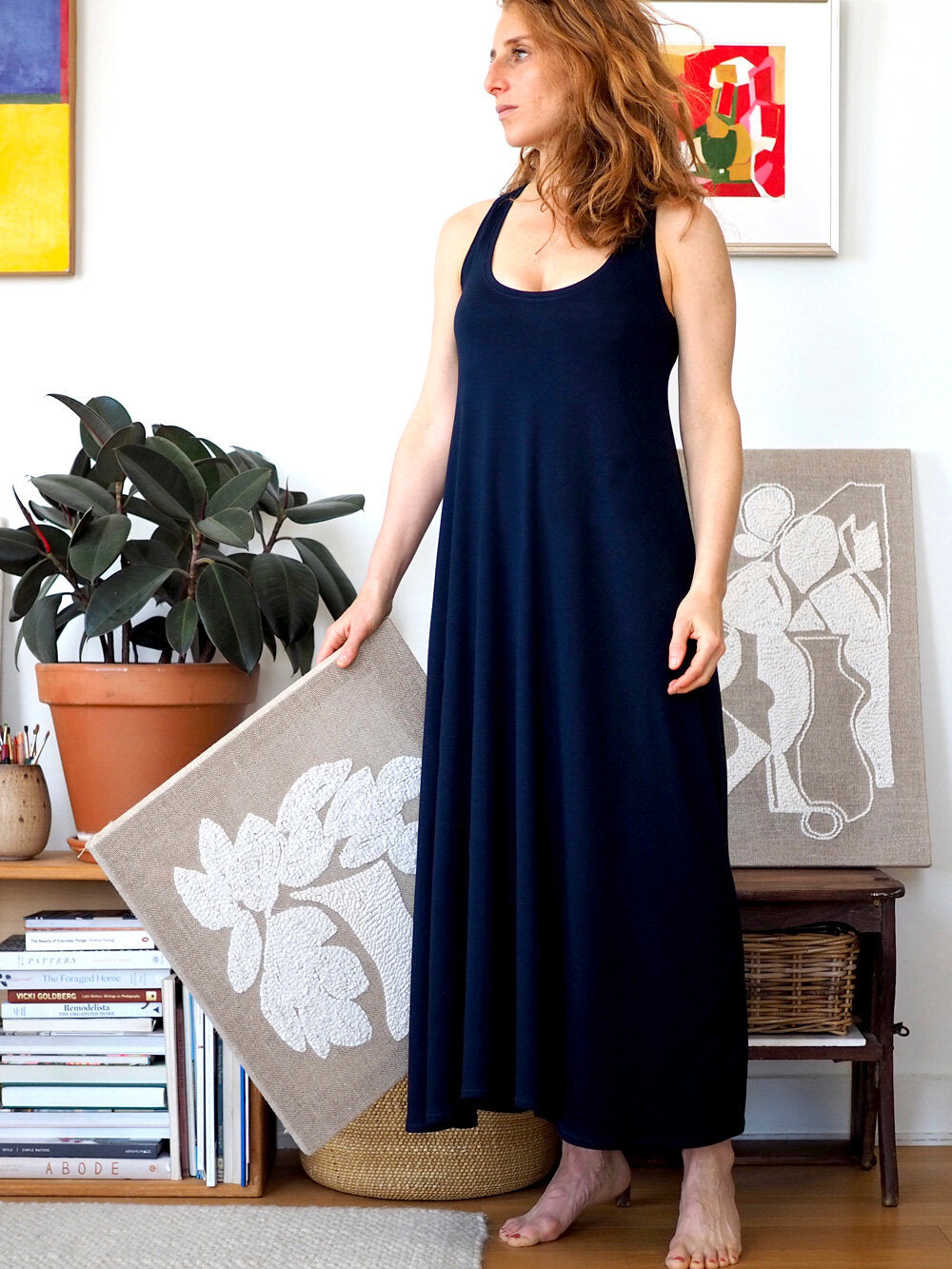 Woman wearing the Rumi Tank Dress sewing pattern by Christine Haynes. A sleeveless dress pattern made in cotton, silk, rayon, bamboo or linen knit fabrics, featuring a racer back, deep scoop neck, fitted through the upper body and bust, then flares to an