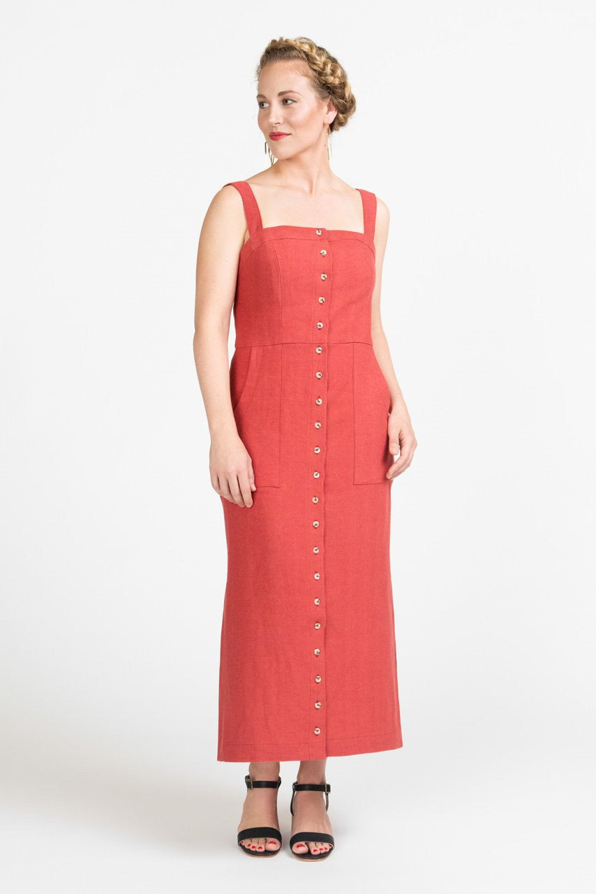 Woman wearing the Fiona Sundress sewing pattern by Closet Core Patterns. A sleeveless, fitted dress pattern made in denim, twill, chambray or linen fabric featuring a button front, shoulder straps, princess seams, and pockets.