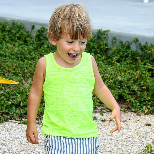 Child wearing the Child/Baby Basic Tank sewing pattern from Elemeno Patterns on The Fold Line. A tank top pattern made in lightweight cotton knit or ribbing fabrics, featuring broad shoulder straps, round neck and no sleeves.