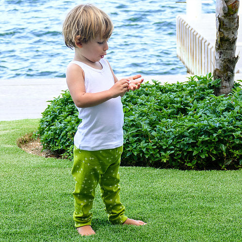 Child wearing the Child/Baby Basic Leggings sewing pattern from Elemeno Patterns on The Fold Line. A leggings pattern made in stretch cotton fabrics, featuring a relaxed fit, elasticated waist and full leg length.