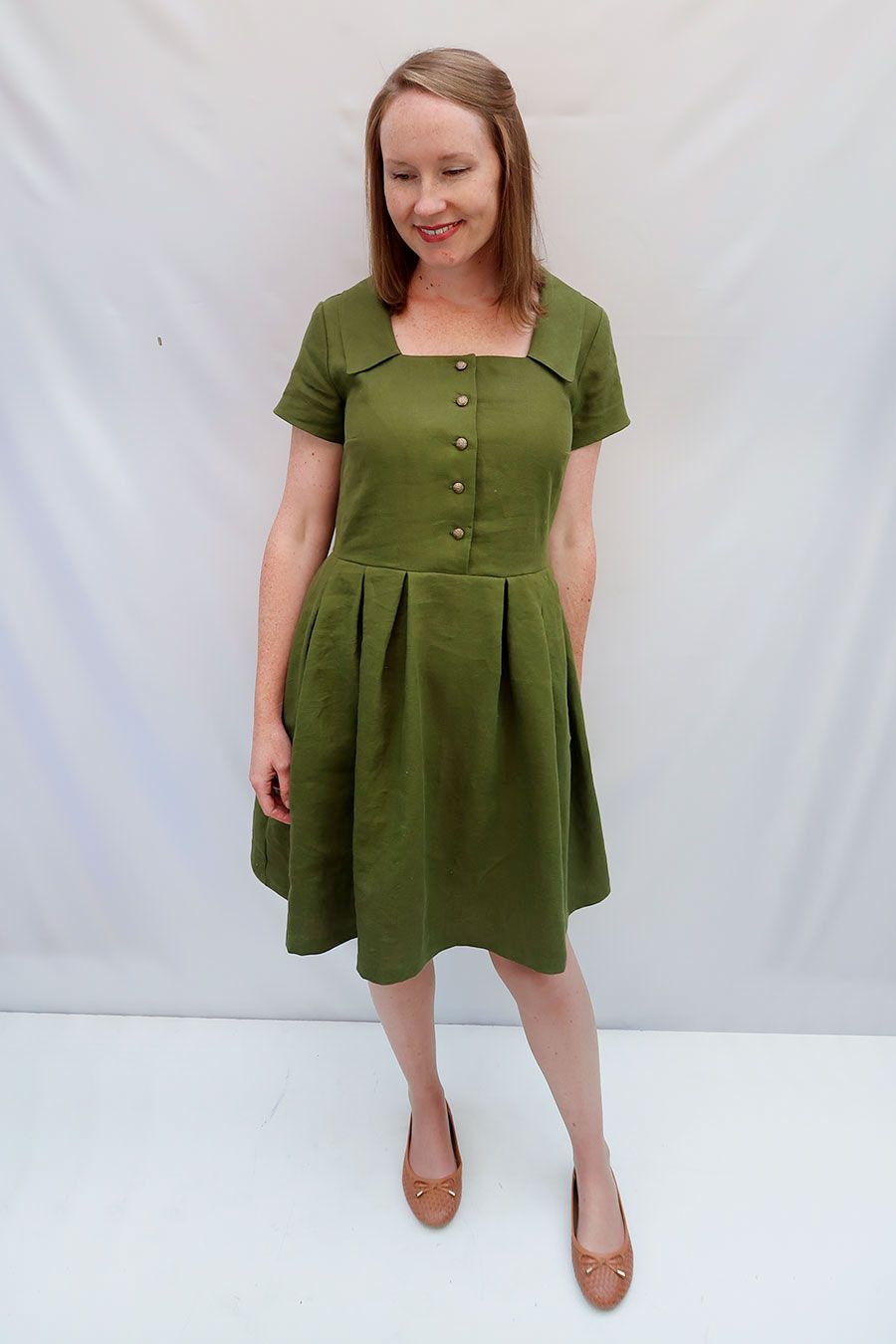 Woman wearing the Asteria Dress sewing pattern from Jennifer Lauren Handmade on The Fold Line. A dress pattern made in cotton lawn, voile, poplin, linen, chambray, rayon, silks, denims, pinwale cords, flannel, wool and wool blends fabrics, featuring a squ