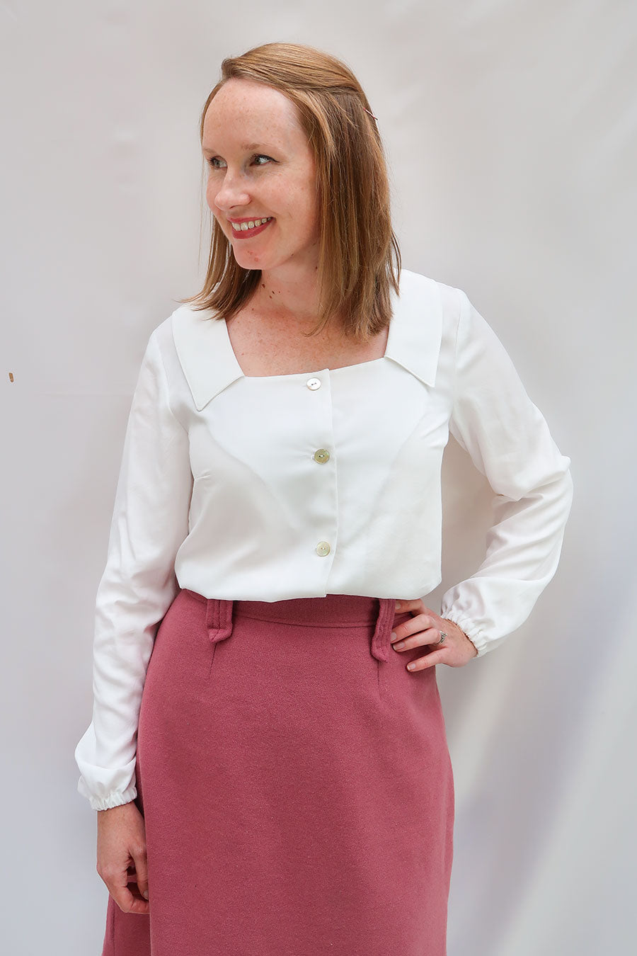 Woman wearing the Aisling Blouse sewing pattern from Jennifer Lauren Handmade on The Fold Line. A blouse pattern made in cotton lawn, voile, poplin, linen, chambray, rayon, silks and sheer fabrics, featuring a full button-down bodice, bust darts, square n