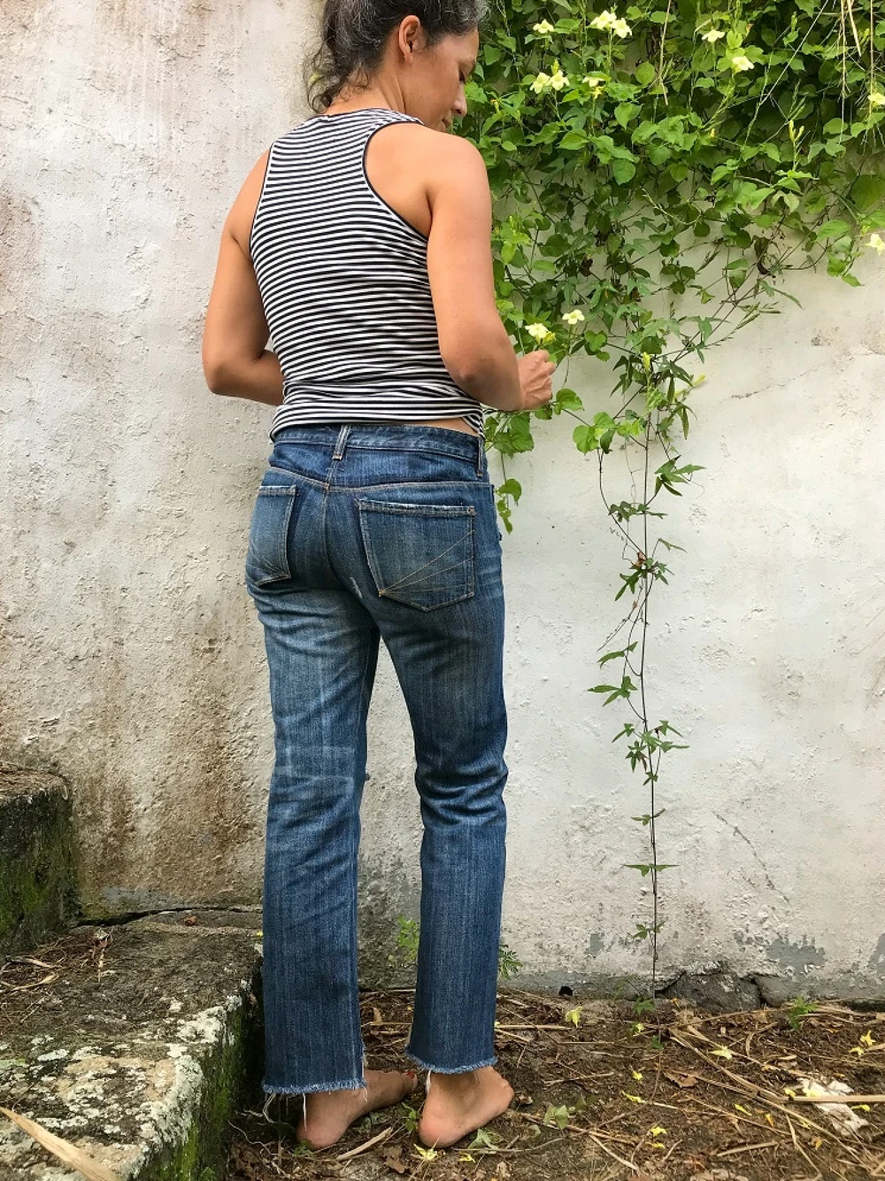 Woman wearing the Halfmoon 101 Jeans pattern from Halfmoon Atelier on The Fold Line. A jeans pattern made in denim fabrics, featuring a lower-rise, straight leg, snug fit around the hips and upper thighs, front pockets and back patch pockets.