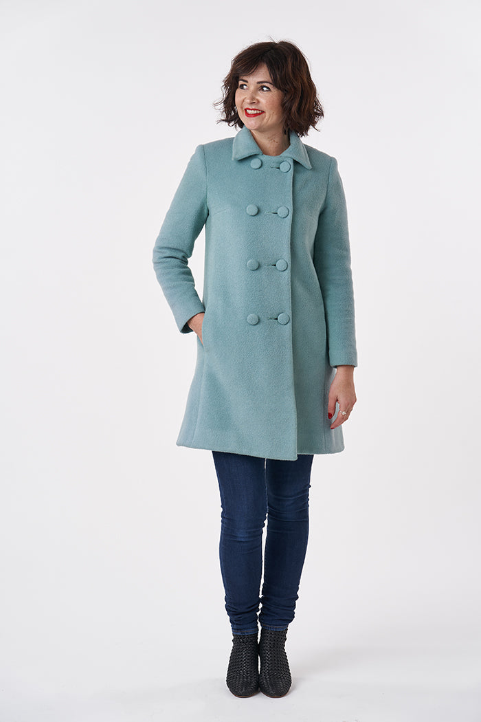 Woman wearing the 1960s Coat sewing pattern from Sew Over It on The Fold Line. A fitted coat pattern made in tweed, boucle, melton, jacquard or boiled wool fabrics, featuring a front button closure, pointed collar, centre back seam, in-seam pockets and ab