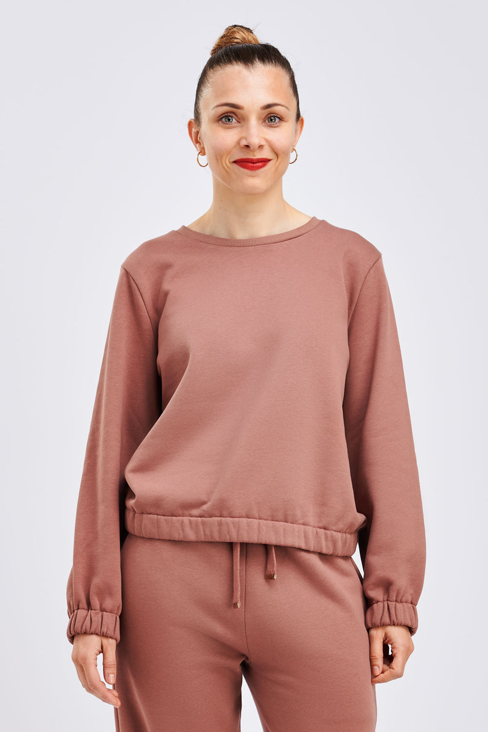 Woman wearing the Baloo Sweatshirt sewing pattern from I AM Patterns on The Fold Line. A sweatshirt pattern made in jersey, sweatshirting, scuba, French terry, or milano jersey fabrics, featuring a relaxed fit, round neck, high hip length with elasticated